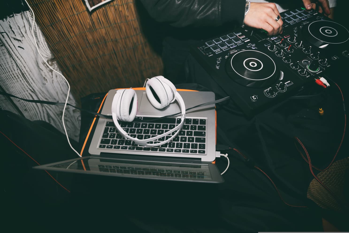 Laptop with headphones and DJ controller